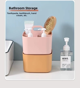 Detail of pink and orange divided plastic organizer basket for bathroom toiletries