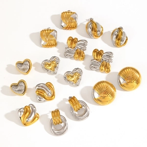 Detail of 18k two-tone stainless steel earrings featuring heart and knotted designs