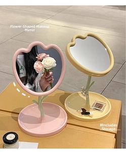 Detail of tulip shaped makeup mirror with storage tray in pink and cream yellow