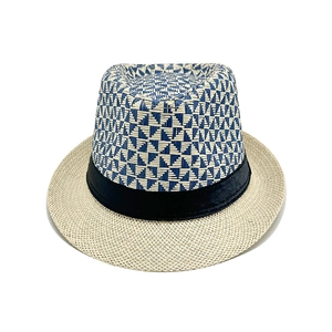 Top view of a woven straw fedora hat featuring blue and white geometric crown patterns
