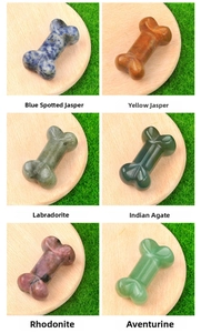 Macro display of bone-shaped natural crystals including Jasper and Agate on wooden trays