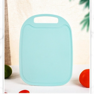 Mint green plastic cutting board with anti-spill groove and handle for fruits