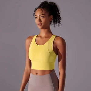 Close-up of bright yellow sports bra with wide straps and high-elastic fabric for fitness
