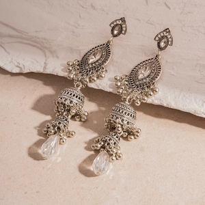 Detail of vintage silver Jhumka earrings with crystals and hanging metal tassels