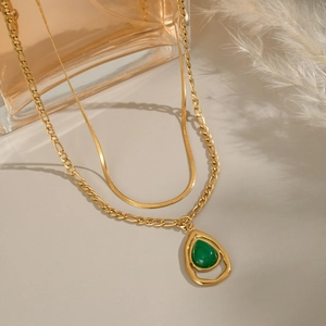 Double-layer gold snake and figaro chain necklace with a green teardrop stone pendant