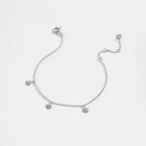 Detailed close-up of S925 sterling silver bracelet featuring three starburst flower charms