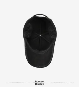 Detail of warm thickened lining and ear protection inside the dark grey winter baseball cap