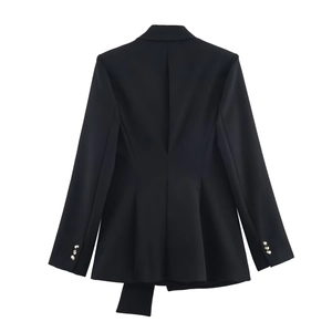 Rear view detail of black slim-fit blazer showing back vent and asymmetric hemline