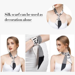 Detail of black and white houndstooth silk scarf worn on neck and wrist as an accessory