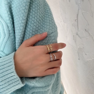 Detailed view of layered S925 silver rings with bubble texture in gold and silver finish