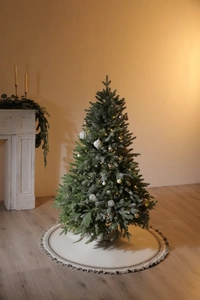 Detail of knitted Christmas tree skirt featuring cozy fringe edges and festive Fair Isle pattern