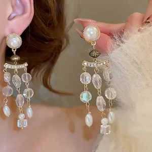 Elegant pearl and crystal tassel earrings with gold base and long shimmering strands