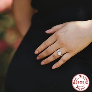 Close-up of 925 sterling silver ring with a sparkling solitaire diamond on a hand