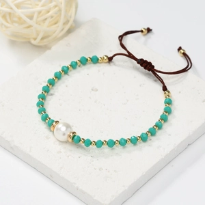 Bohemian pearl and turquoise crystal beaded bracelet set on a white marble base