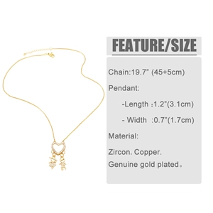 Macro detail of gold plated heart pendant with boy girl charms and zircon inlay