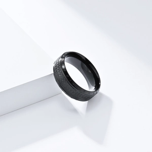 Detail of Viking runes and Celtic knot texture on matte black steel ring band