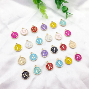 Close-up of colorful round alloy alphabet pendants for DIY jewelry making