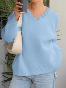Detail shot of light blue V-neck knit sweater showing soft texture and long sleeves