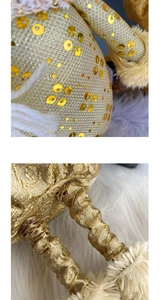 Detail of golden sequin fabric and plush trim on a Christmas doll decoration