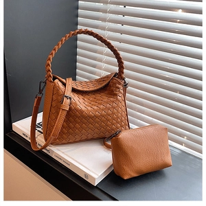 Close-up of brown woven leather handbag set featuring detailed Intrecciato craftsmanship