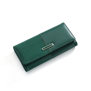Detail of dark green patchwork wallet showing textured PU leather and gold nameplate