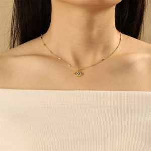 Chic gold-plated evil eye necklace with blue enamel pendant shown on model