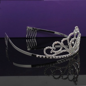 Elegant bridal crystal tiara with heart pattern and anti-slip hair comb on mirror surface