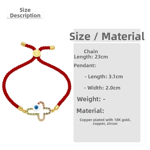 Detailed view of red braided bracelet with colorful zircon cross and evil eye charm
