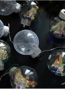 Detailed view of clear Christmas balls with iridescent laser fill and gold moon stars mesh