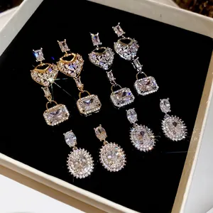 Elegant square zircon earrings set in gold and silver finish with heart dangle designs