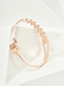 Detailed shot of rose gold leaf bracelet featuring a spring clasp and polished finish