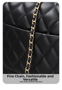 Detail of classic black quilted leather bag with adjustable gold metal chain strap