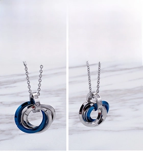 Detail of interlocking triple ring pendant with blue electroplating and zircon stones