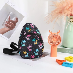 Detailed close-up of a black nylon kids chest bag featuring colorful dinosaur prints