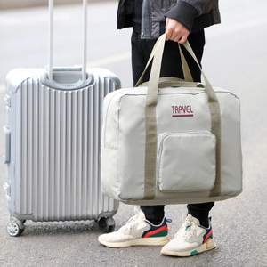 Large capacity light grey travel bag shown in outdoor setting for versatile travel storage
