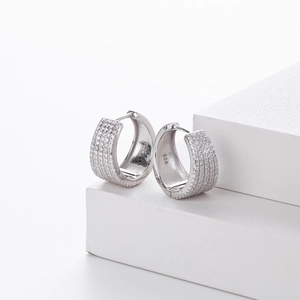 Macro detail of S925 sterling silver hoop earrings with micro-pave cubic zirconia inlay