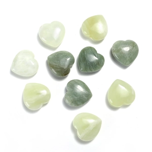 Close-up of ten polished green quartz heart stones on a minimalist white background