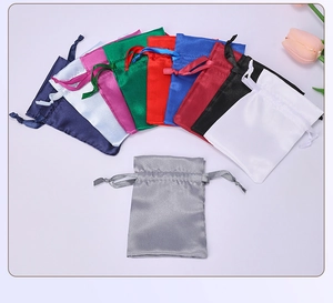 Detailed top view of colorful satin drawstring bags with soft silk texture and glossy finish