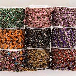 Colorful glitter enamel beads on a gold chain roll for DIY jewelry making