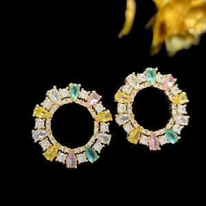 Macro shot of French vintage hoop earrings featuring colorful teardrop-shaped zircons