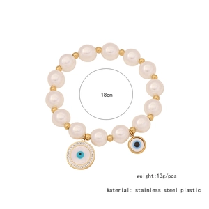 Macro shot of 18cm beaded Evil Eye bracelet with white pearls and stainless steel charms
