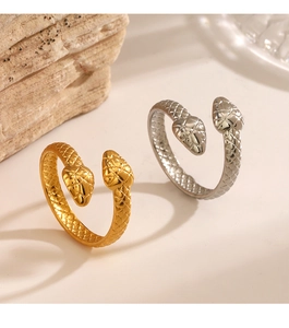 Macro detail of gold and silver snake rings featuring realistic scale textures and open design