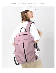 Detail view of pink oxford backpack with waterproof fabric and astronaut charm pendant