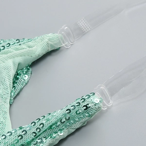Detail of mint green sequin dress showing mesh fabric and clear shoulder strap