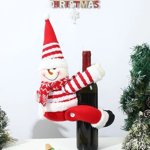 Close-up of a festive knitted snowman wine bottle cover with red striped hat and scarf
