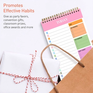 Detailed view of pink daily planner with spiral binding and gift box packaging