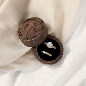 Macro view of walnut wood ring box with It Was Always You engraving and dual ring slots