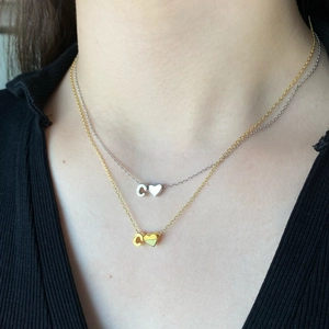 Double layered S925 silver necklace with C-letter and heart pendant on female model