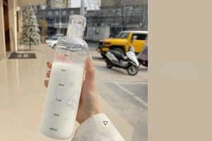 Detail showing transparent plastic water bottle with time markers and rabbit pattern