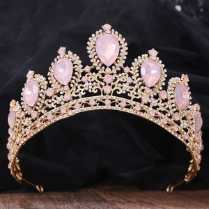 Detailed view of the gold crown with pink crystals and shimmering clear rhinestones